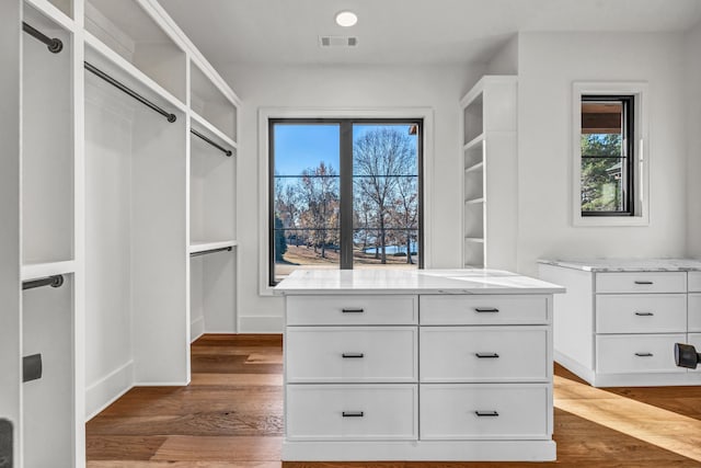 walk in closet with dark wood-style floors and visible vents