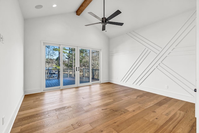 spare room featuring baseboards, french doors, beamed ceiling, and wood finished floors