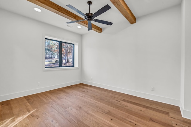 spare room with wood finished floors, baseboards, beamed ceiling, and recessed lighting