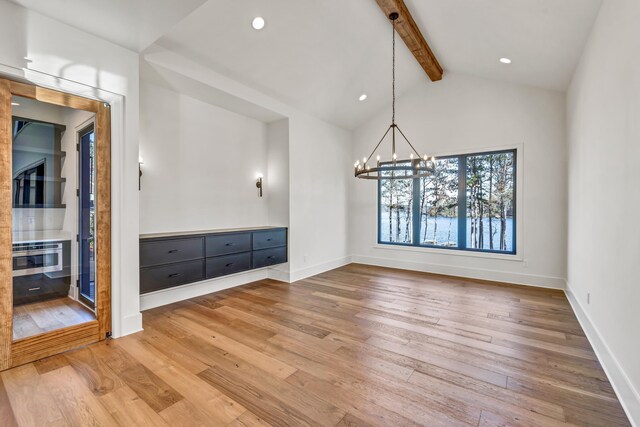 unfurnished dining area with a chandelier, recessed lighting, vaulted ceiling with beams, baseboards, and wood finished floors