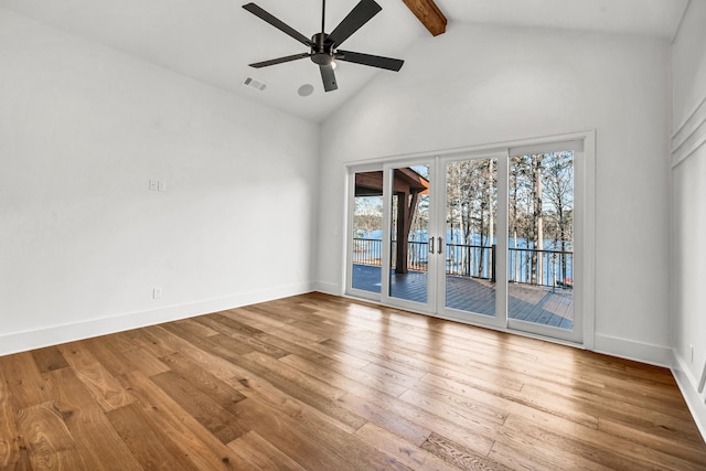 spare room with beam ceiling, visible vents, light wood-type flooring, and french doors