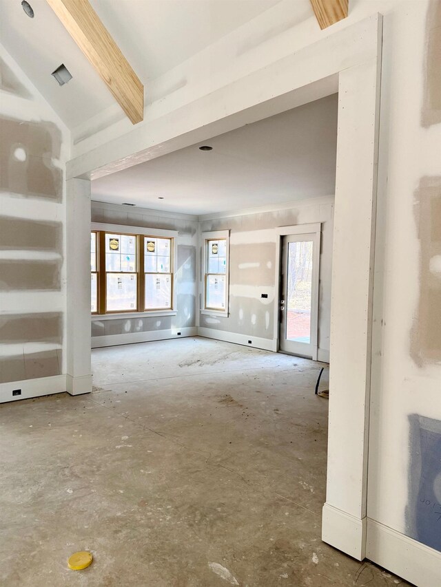 interior space featuring beam ceiling and baseboards