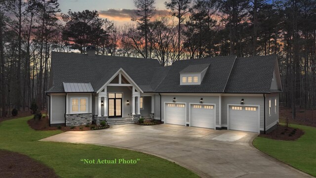 modern farmhouse style home with roof with shingles, an attached garage, a chimney, concrete driveway, and a lawn