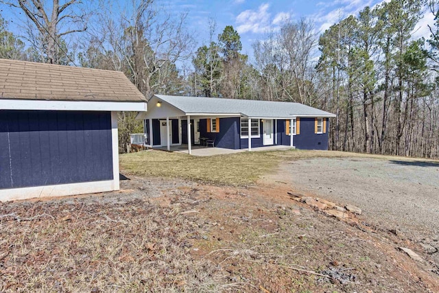 single story home with a patio area and a front lawn