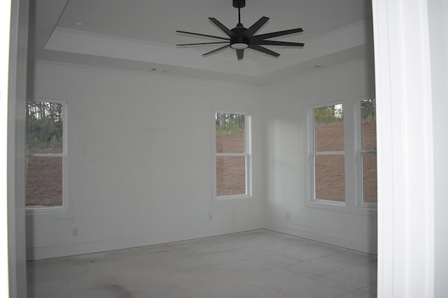 unfurnished room featuring crown molding, ceiling fan, a raised ceiling, and a wealth of natural light