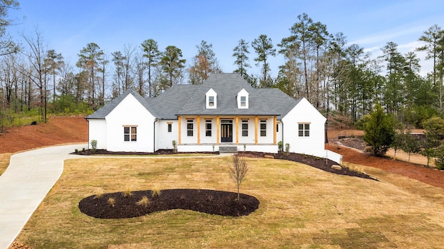 view of front of house with a front yard and covered porch