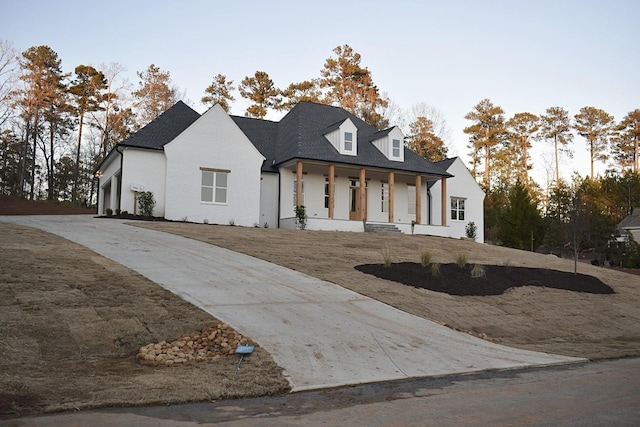 view of front of home featuring a garage and covered porch