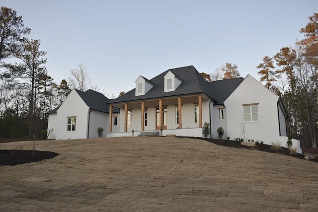 view of front of house with a front lawn and a porch