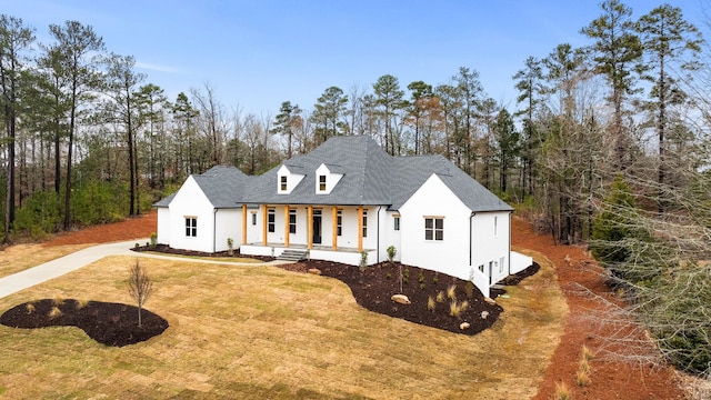 view of front of house featuring covered porch and a front lawn