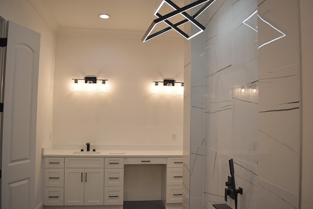 bathroom featuring ornamental molding and vanity