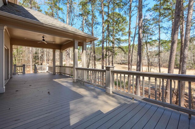 wooden terrace featuring a ceiling fan