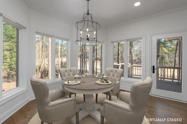 sunroom / solarium featuring a chandelier