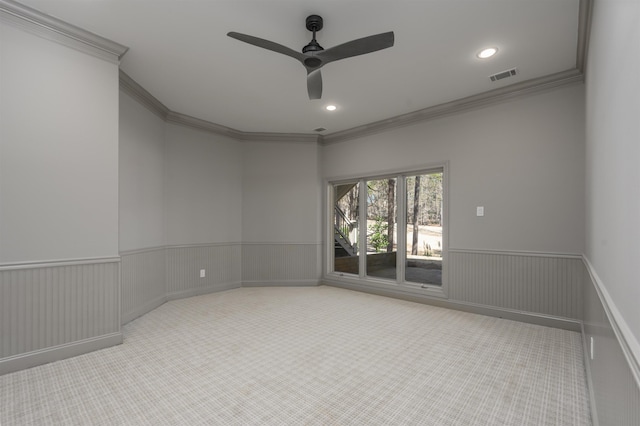 spare room featuring a wainscoted wall, carpet flooring, recessed lighting, and visible vents