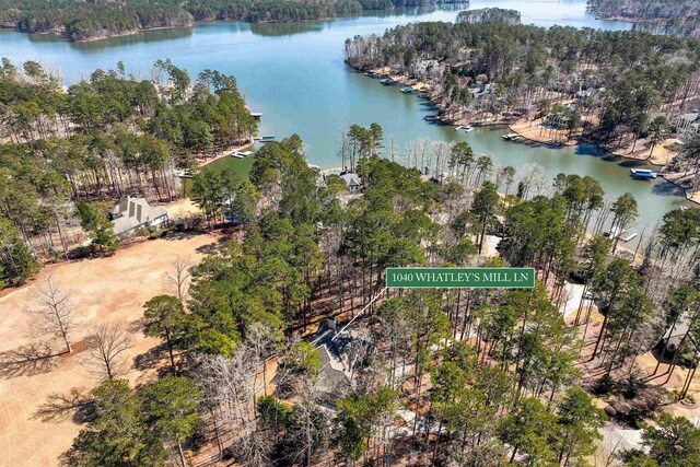 birds eye view of property with a forest view and a water view