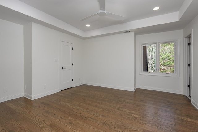 empty room with visible vents, dark wood finished floors, recessed lighting, baseboards, and ceiling fan