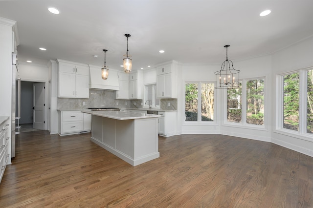 kitchen with decorative backsplash, white cabinets, light countertops, and dark wood-type flooring