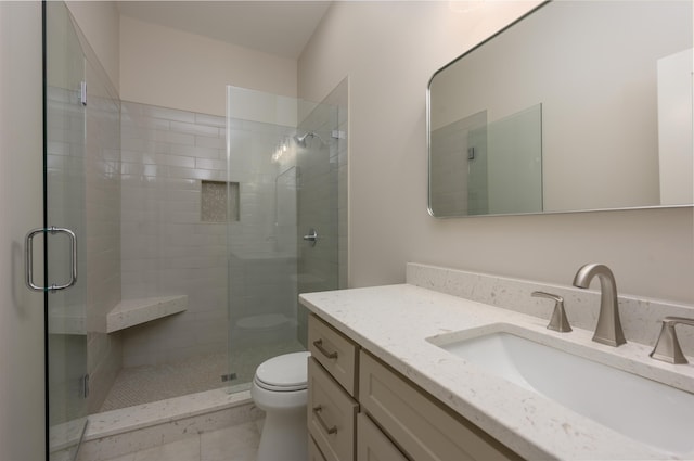 full bathroom with toilet, a stall shower, and vanity