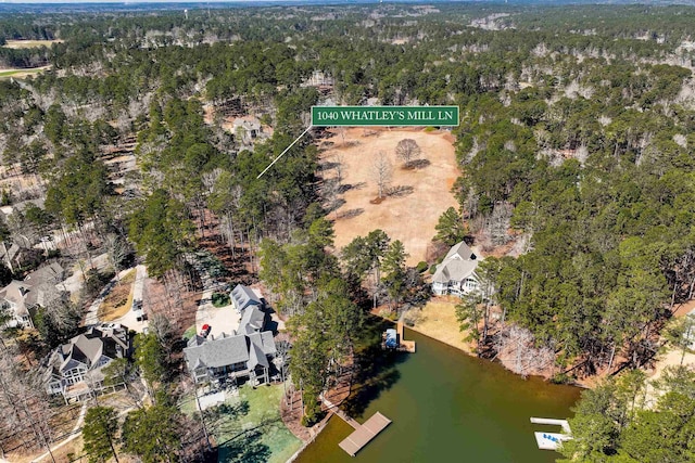 birds eye view of property with a forest view and a water view