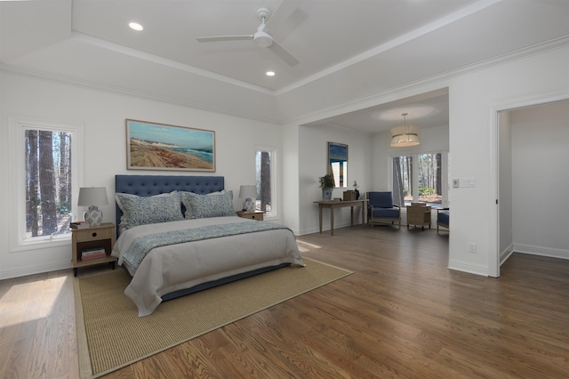 bedroom featuring a raised ceiling, recessed lighting, wood finished floors, and baseboards