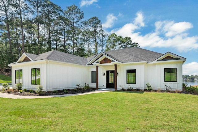 modern farmhouse style home with a front lawn