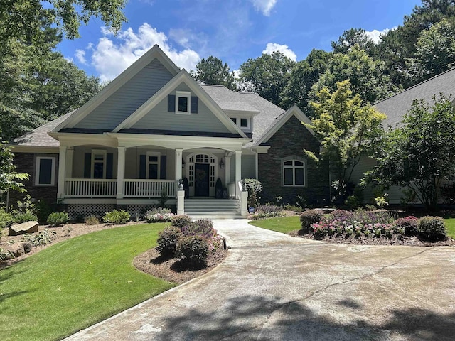 1011 Cartwright Ln, Greensboro, GA 30642 - craftsman house with covered porch, a front lawn, and stone siding