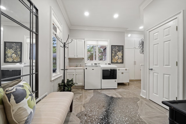 1011 Cartwright Ln, Greensboro, GA 30642 - kitchen featuring washing machine and dryer, ornamental molding, white cabinetry, light countertops, and recessed lighting