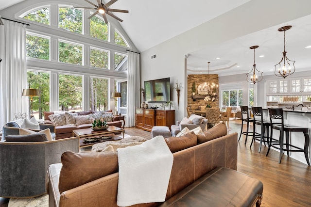 1011 Cartwright Ln, Greensboro, GA 30642 - living room featuring a chandelier, a ceiling fan, high vaulted ceiling, wood finished floors, and recessed lighting