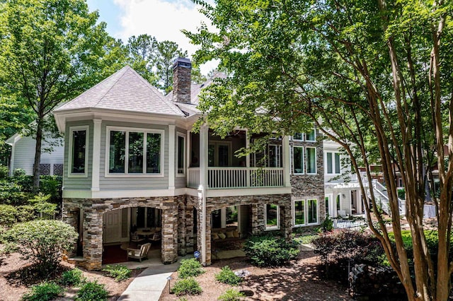 1011 Cartwright Ln, Greensboro, GA 30642 - rear view of house with stone siding, a chimney, a patio area, and a shingled roof