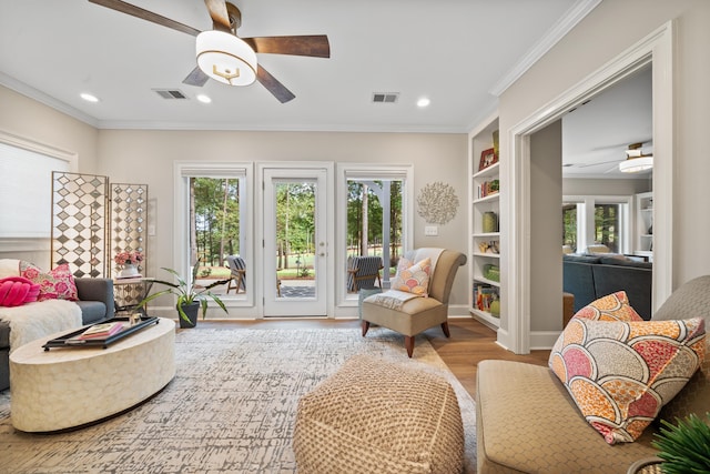 1011 Cartwright Ln, Greensboro, GA 30642 - sitting room with a ceiling fan, wood finished floors, crown molding, recessed lighting, and built in features