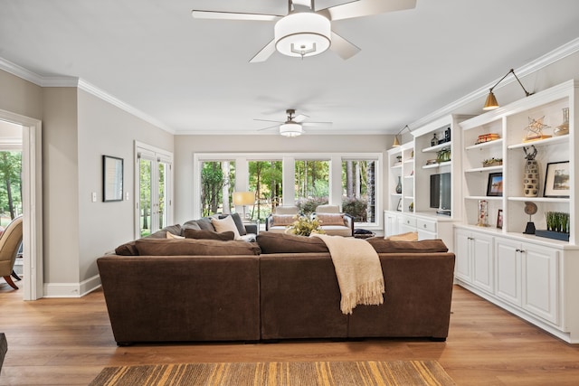 1011 Cartwright Ln, Greensboro, GA 30642 - living room featuring a ceiling fan, light wood-style floors, plenty of natural light, and ornamental molding