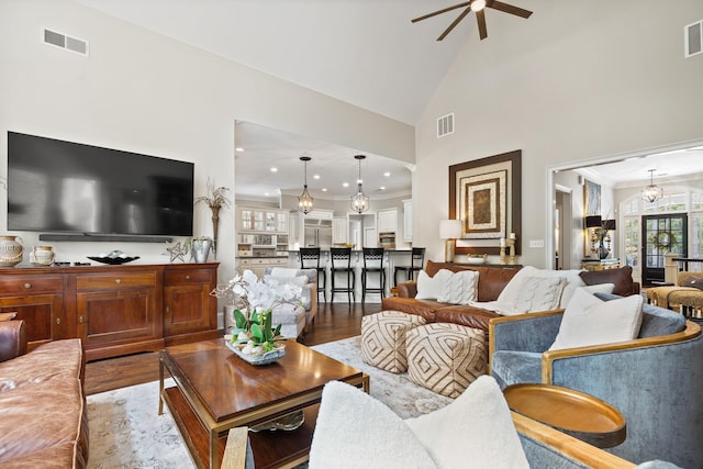 1011 Cartwright Ln, Greensboro, GA 30642 - living area featuring wood finished floors, ceiling fan, high vaulted ceiling, recessed lighting, and crown molding