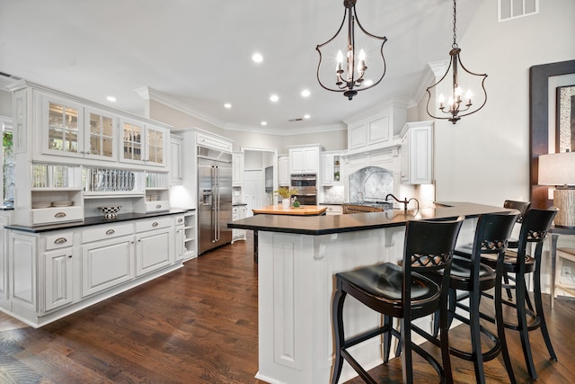 1011 Cartwright Ln, Greensboro, GA 30642 - kitchen with stainless steel built in refrigerator, dark countertops, a chandelier, recessed lighting, and a breakfast bar area