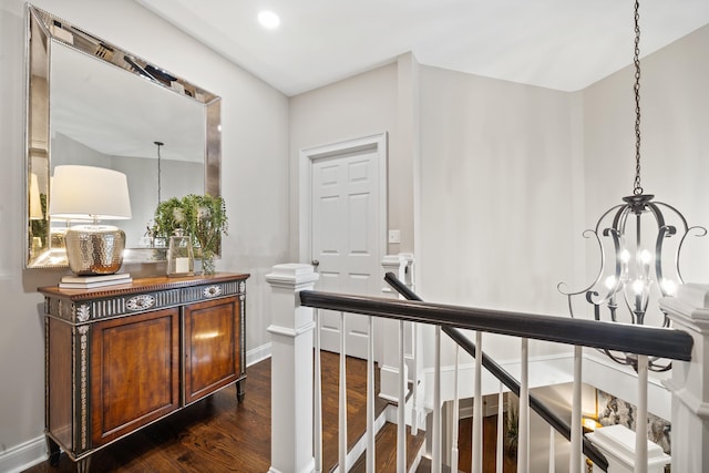 1011 Cartwright Ln, Greensboro, GA 30642 - corridor featuring a chandelier and dark wood-type flooring