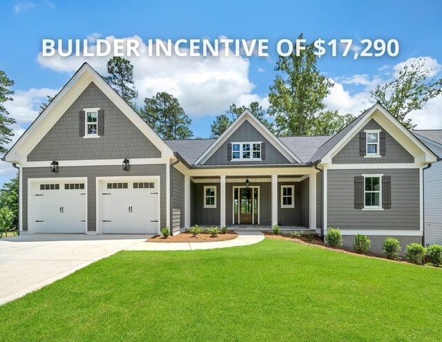 craftsman-style house with a garage, a front yard, and covered porch