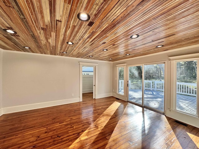 unfurnished room with hardwood / wood-style flooring, ornamental molding, and wooden ceiling