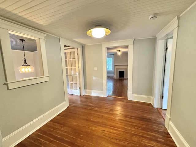 hallway with crown molding and dark hardwood / wood-style floors