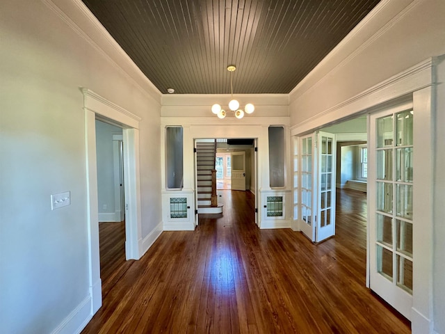 unfurnished dining area with ornamental molding, plenty of natural light, dark hardwood / wood-style floors, and french doors