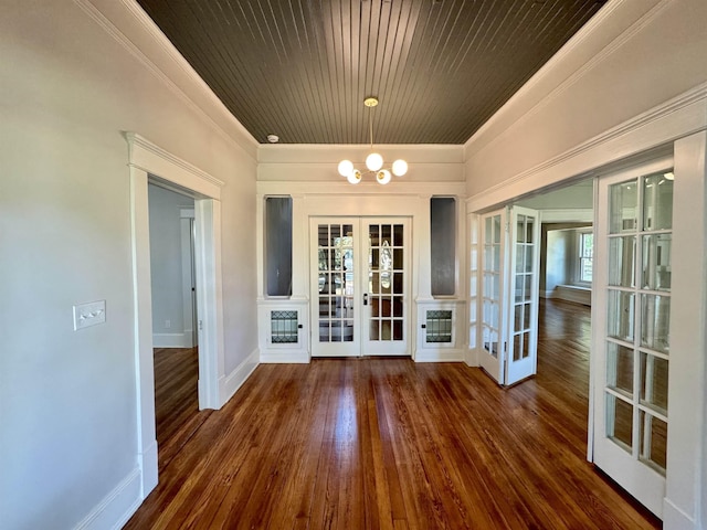 interior space with ornamental molding, wooden ceiling, dark hardwood / wood-style flooring, and french doors