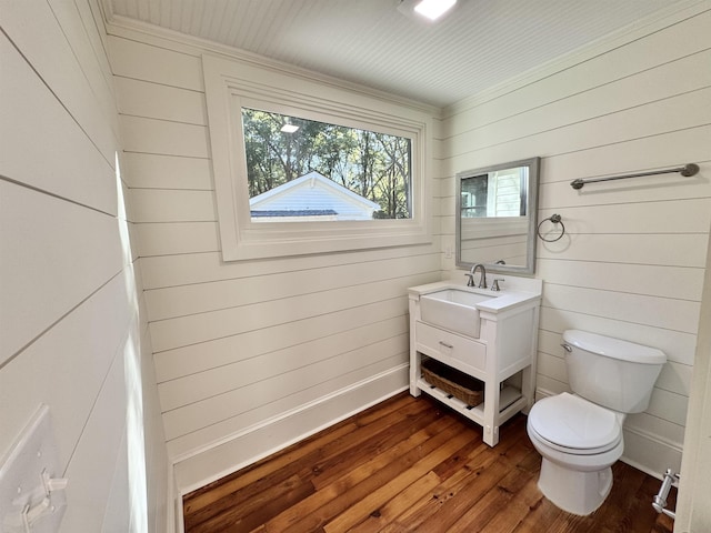 bathroom with wood-type flooring, toilet, and vanity