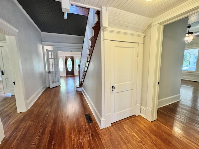 corridor featuring crown molding, hardwood / wood-style floors, and wood ceiling