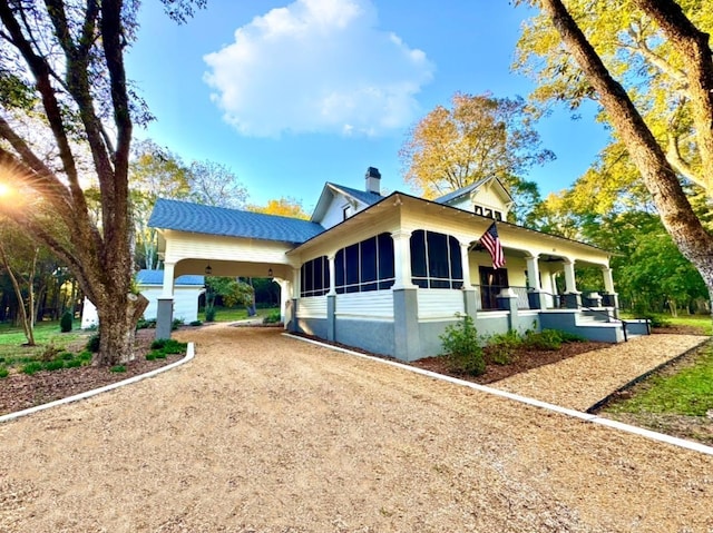 view of front of house featuring a carport and covered porch