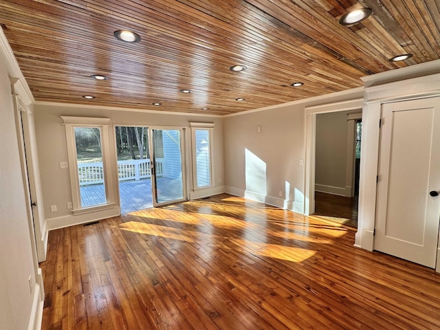 unfurnished room featuring hardwood / wood-style flooring, wood ceiling, and ornamental molding