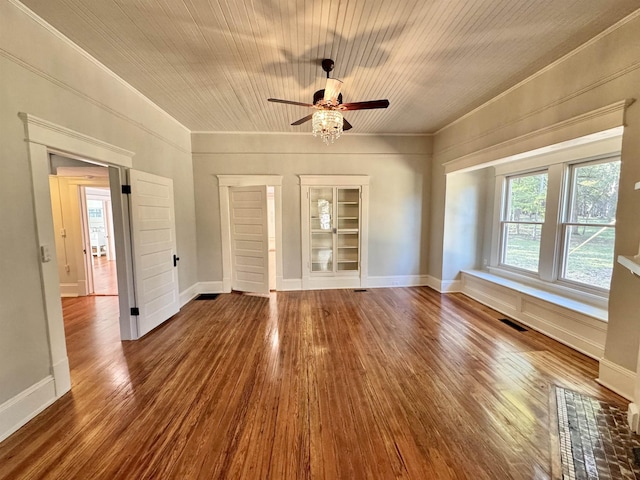 interior space with wood-type flooring, ceiling fan, crown molding, and built in shelves