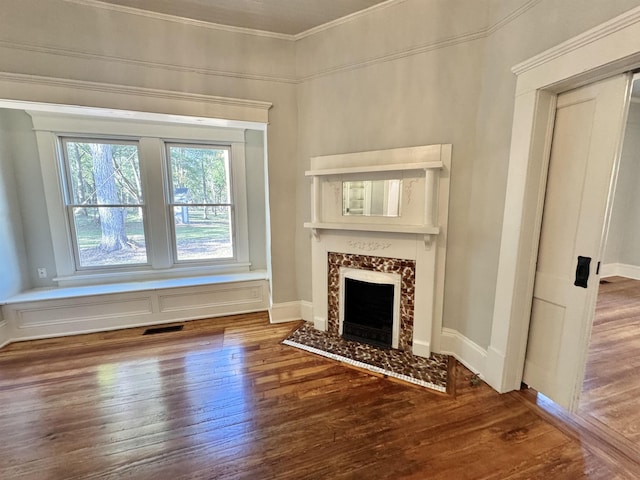 unfurnished living room featuring ornamental molding, dark hardwood / wood-style floors, and a high end fireplace