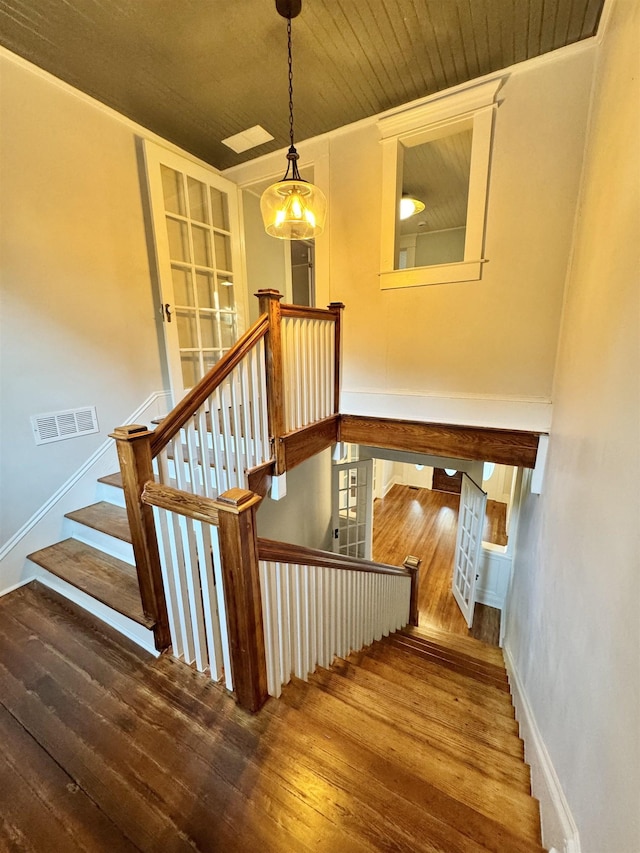 staircase with hardwood / wood-style floors