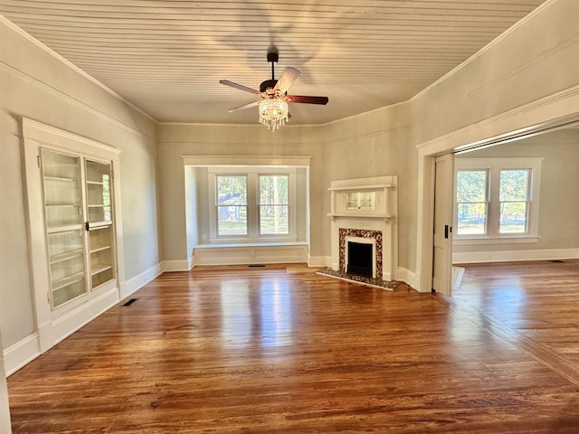 unfurnished living room with a premium fireplace, dark hardwood / wood-style floors, and a wealth of natural light