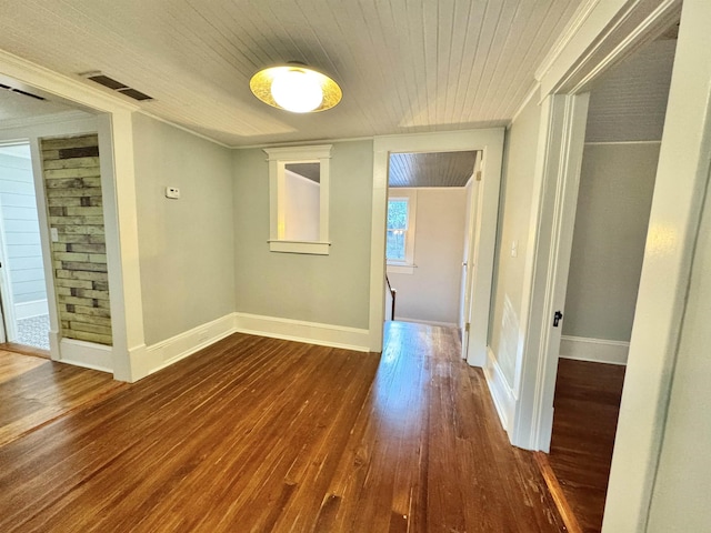 hallway featuring wood-type flooring, ornamental molding, and wooden ceiling