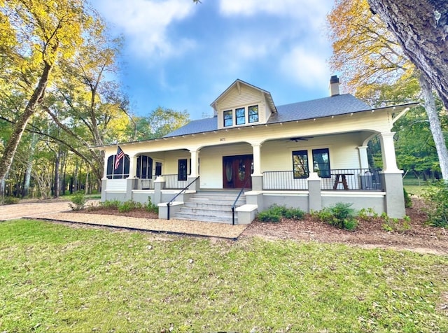 view of front of property with a porch and a front lawn