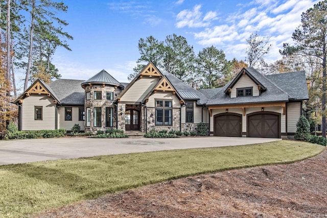 view of front of home with a garage and a front yard