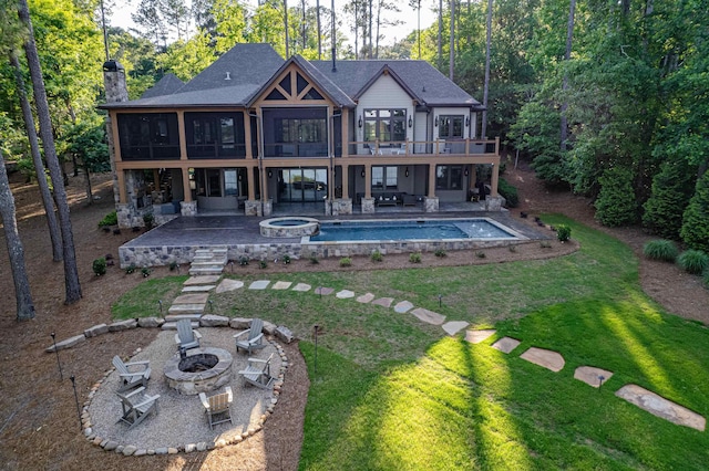 1031 Fish Trap Shls, Greensboro, GA 30642 - rear view of house featuring a fire pit, a patio, a yard, and a sunroom